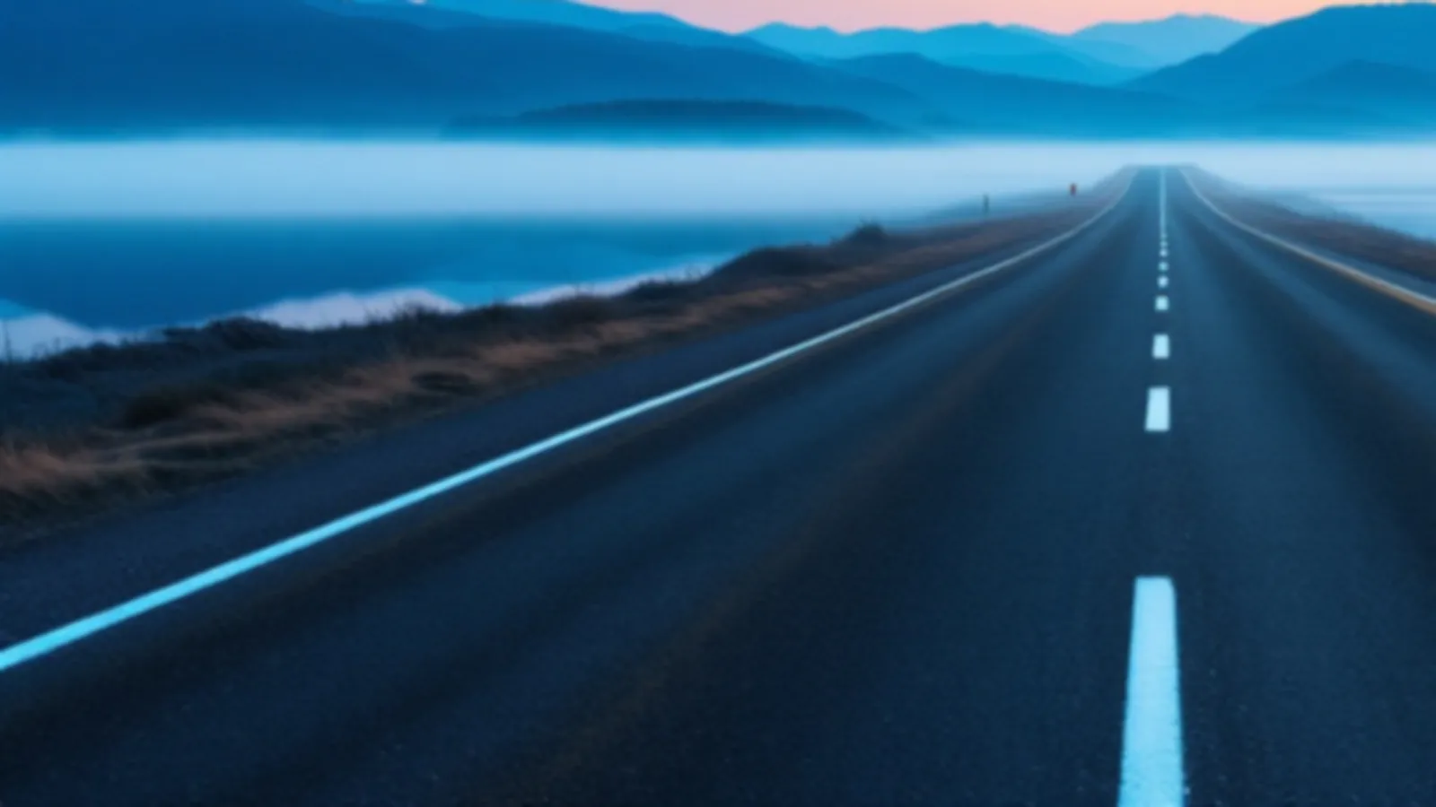 An empty lakeside road at dawn with mist on the water and blue hills beyond, the CoupeMoney view of cash advance online, $100 – $5,000